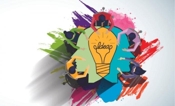 Paintbrush swipes with different colours showing people sat around a table with a lightbulb in the middle.