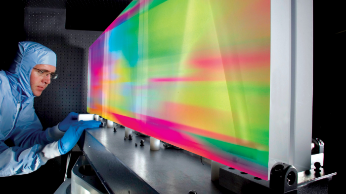 Man working in a factory on a multicoloured lightboard