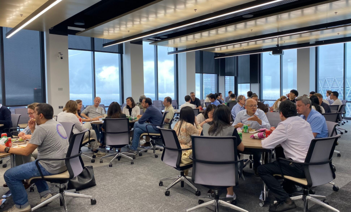 A picture from the FTG Conference. Groups of people sat around tables at Canary Wharf.