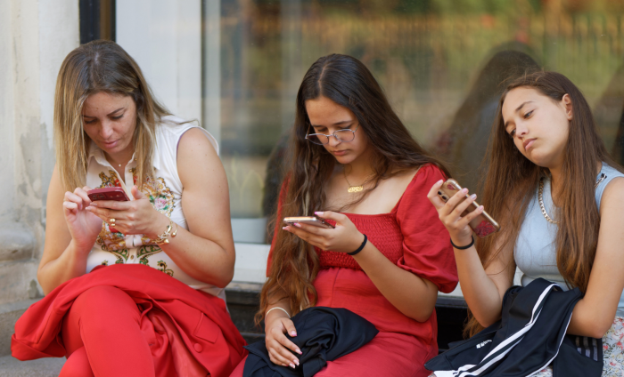 Three women on their phones and not talking to one and other 